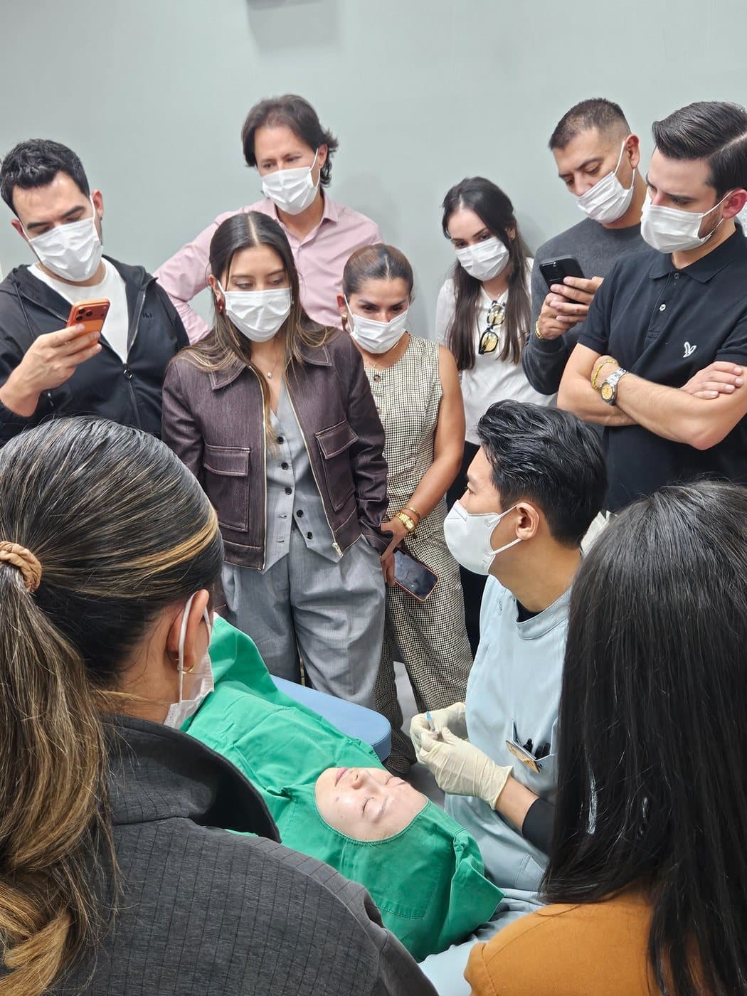 Visiting clinicians observing a full-face live demonstration