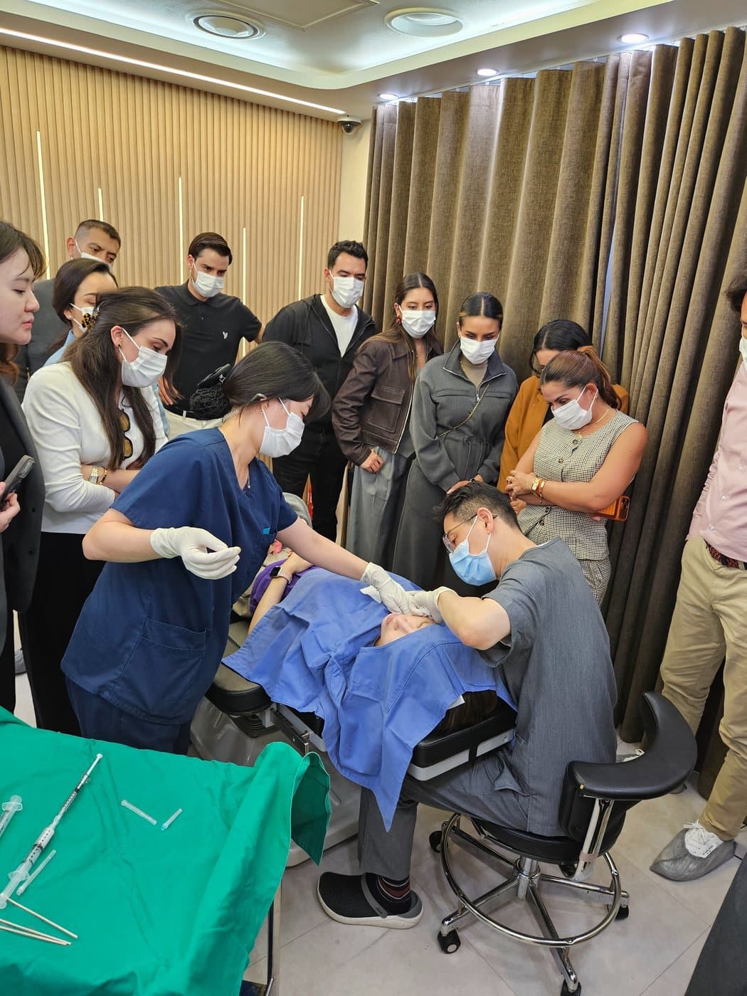 Visiting clinicians observing a live neck-line demonstration at HERA