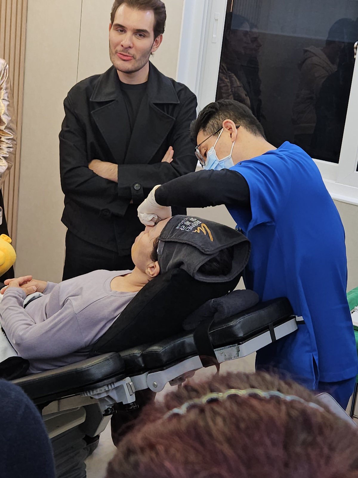 A visiting Brazilian physician observing the injection technique at close range