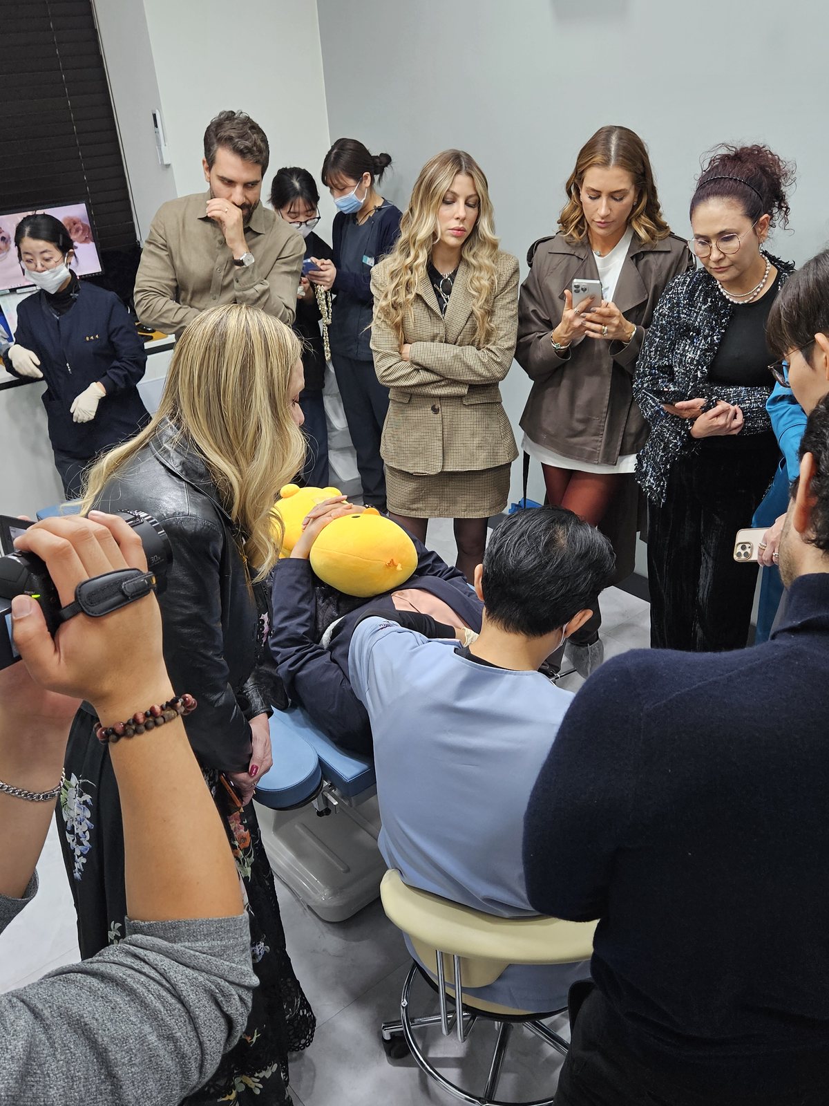 Visiting physicians gathered around the treatment chair during the live demonstration